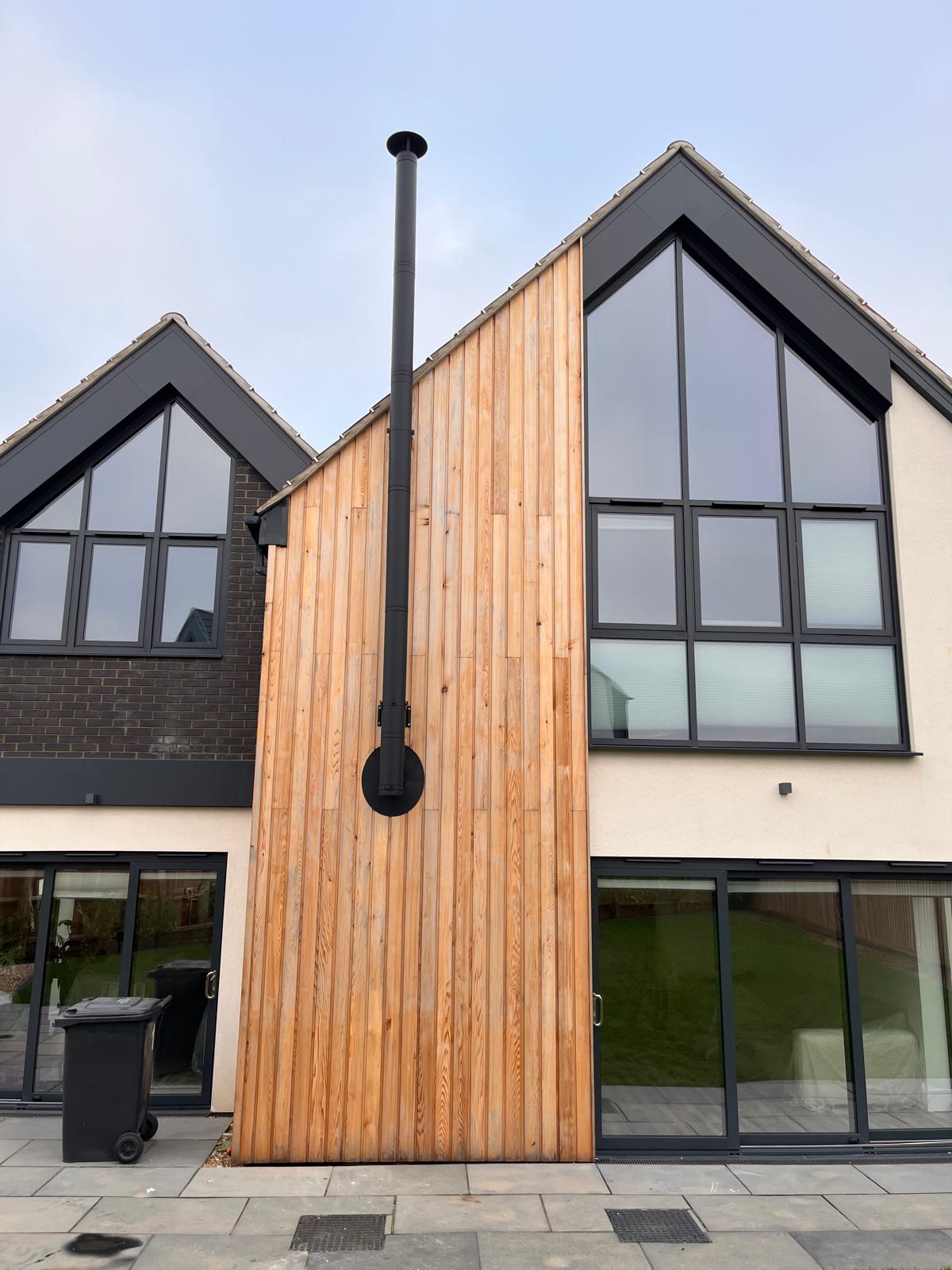 External twin wall flue installation with timber cladding on Norfolk property — Watmore's Woodburners