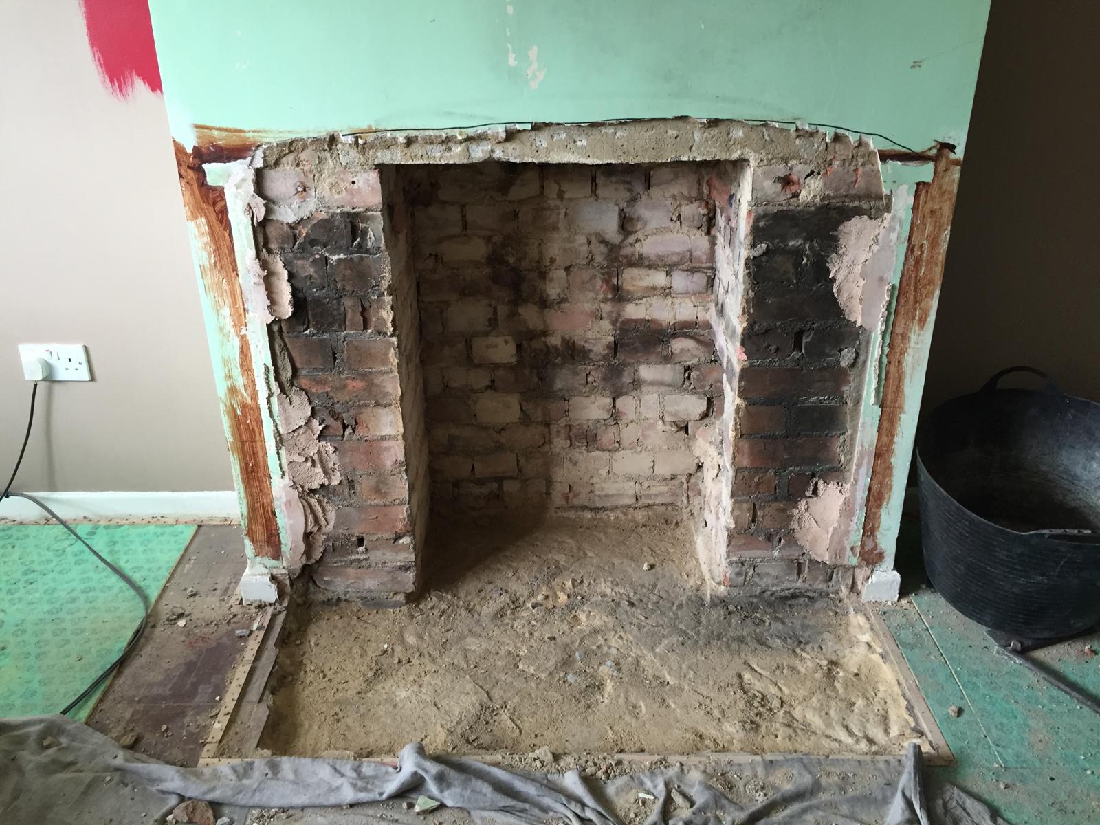 Exposed fireplace opening during woodburner installation preparation — Norfolk