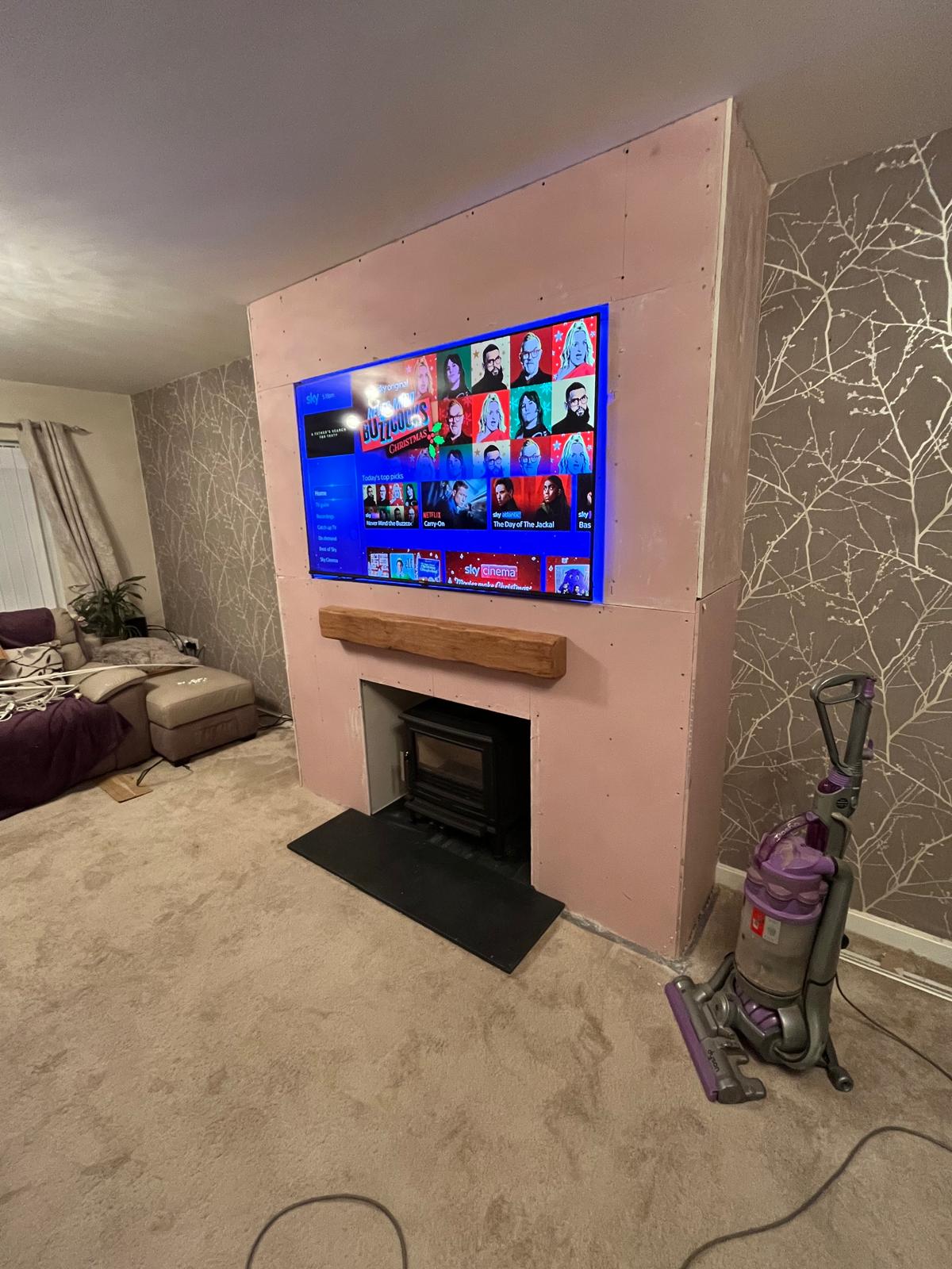 Close up of completed woodburner installation with oak fireplace beam — Watmore's Woodburners, Norfolk